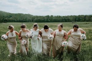 bridal party in the field by ocoee river barn wedding venue