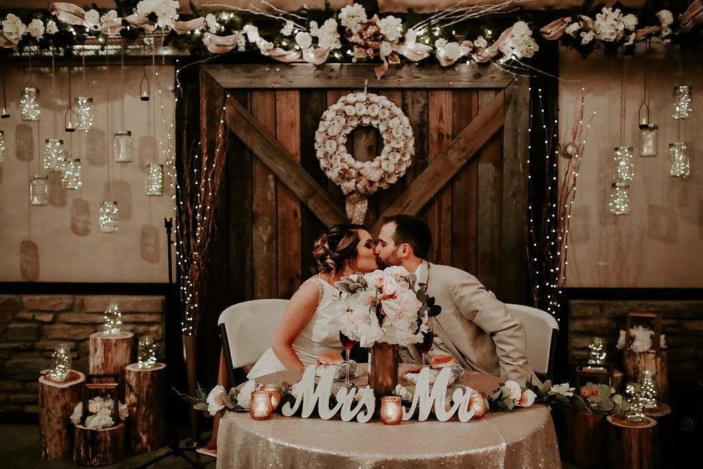 bride and groom table at rustic barn wedding venue
